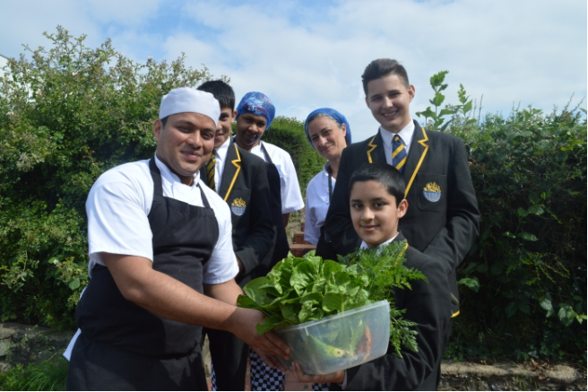 Staff and students with fresh produce outside